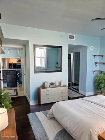 a living room with stainless steel appliances furniture and a window