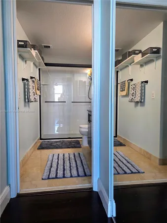 a kitchen with a sink and a large mirror