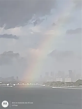 a kitchen with stainless steel appliances granite countertop a refrigerator a stove and a sink with granite countertops