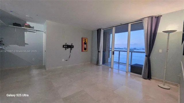 a view of a lake with a yard and large trees