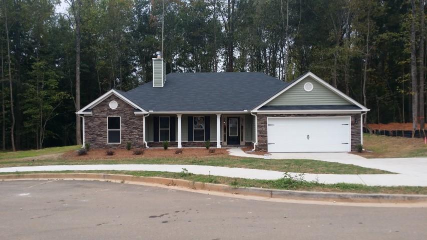 187 Evergreen Ridge Statham, GA 30666 - Photo 1 of 1 a front view of a house with a yard and garage