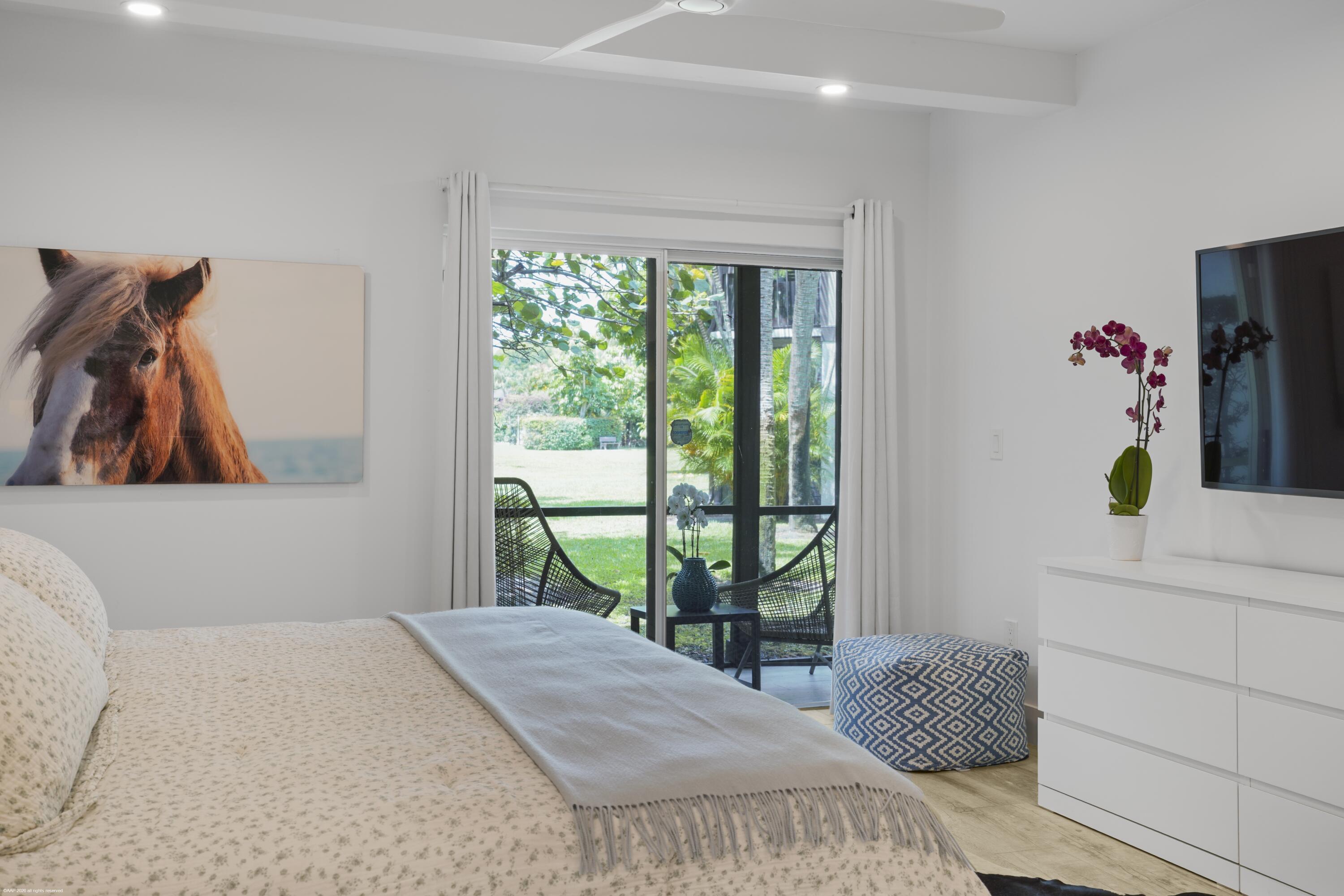 13334 Polo Club Road, Unit 234 Wellington, FL 33414 - Photo 12 of 41 a bedroom with a bed and a window