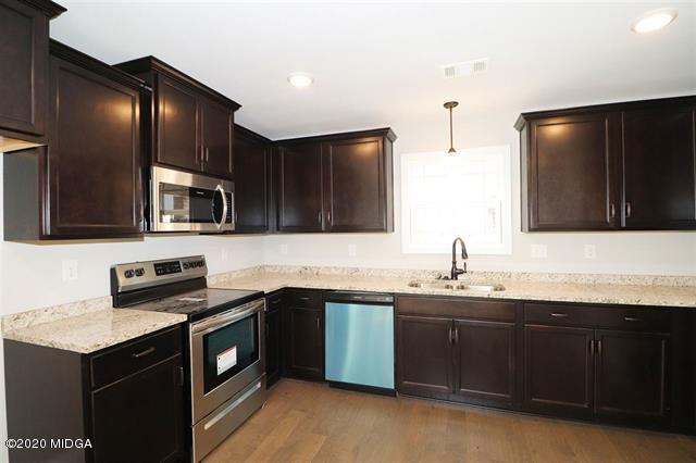 116 Hawks Ridge Byron, GA 31008 - Photo 2 of 34 a kitchen with stainless steel appliances granite countertop a sink stove and oven