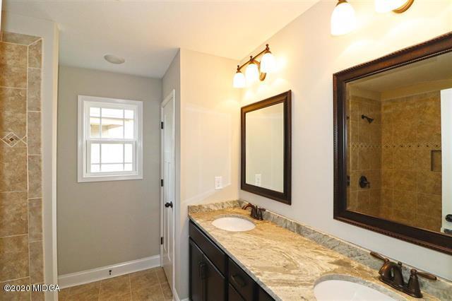 116 Hawks Ridge Byron, GA 31008 - Photo 18 of 34 a bathroom with a granite countertop sink and a mirror