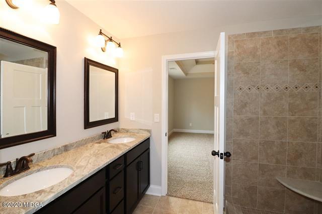 116 Hawks Ridge Byron, GA 31008 - Photo 19 of 34 a bathroom with a granite countertop sink and a mirror