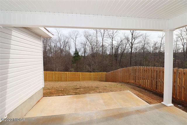 116 Hawks Ridge Byron, GA 31008 - Photo 30 of 34 a view of backyard with large trees and plants