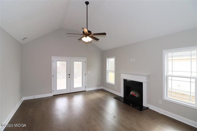 116 Hawks Ridge Byron, GA 31008 - Photo 5 of 34 a view of an empty room with wooden floor and a window