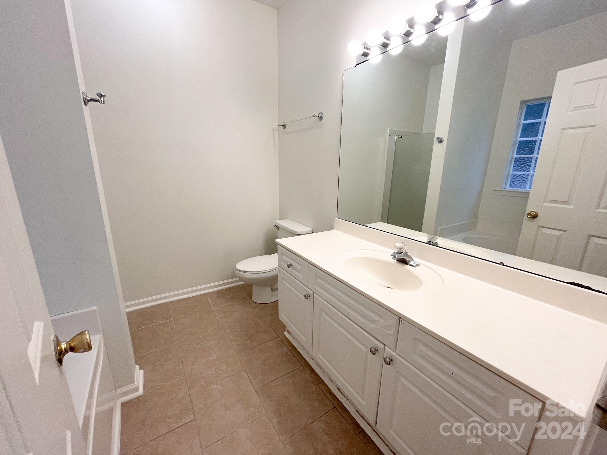 3079 River Ridge Drive Gastonia, NC 28056 - Photo 15 of 24 a bathroom with a double vanity sink a toilet and a mirror