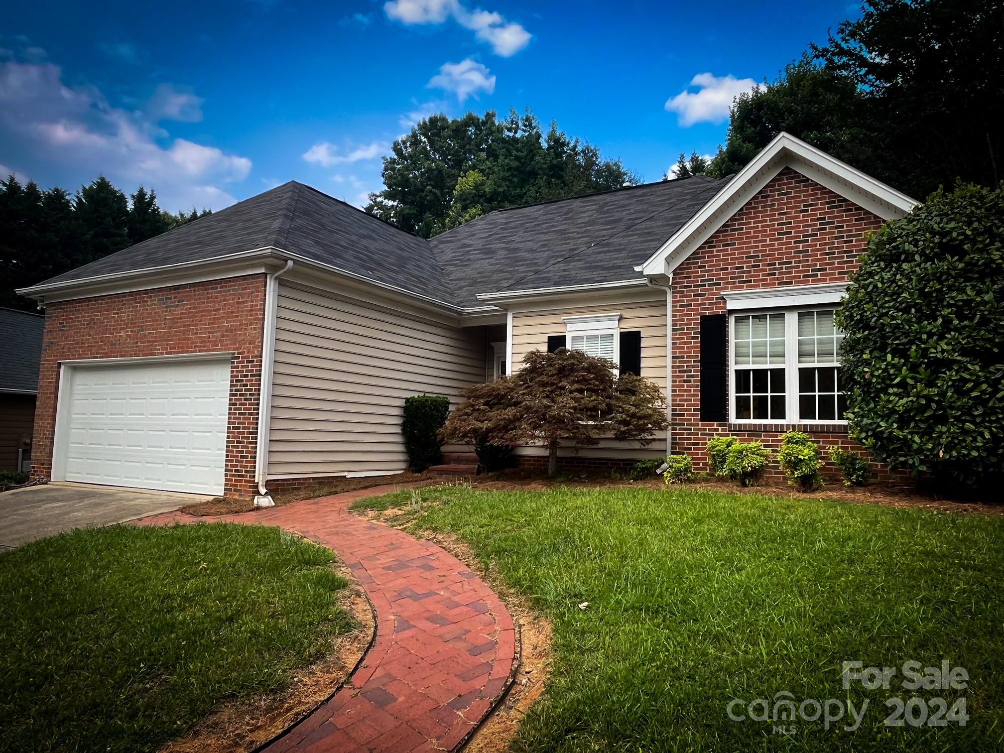 3079 River Ridge Drive Gastonia, NC 28056 - Photo 2 of 24 a front view of a house with a garden
