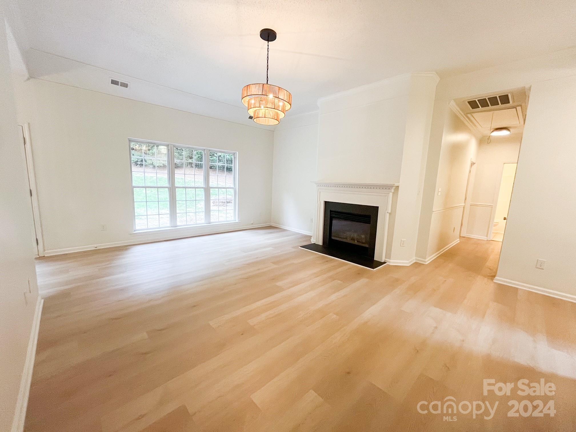 3079 River Ridge Drive Gastonia, NC 28056 - Photo 3 of 24 an empty room with fireplace and windows