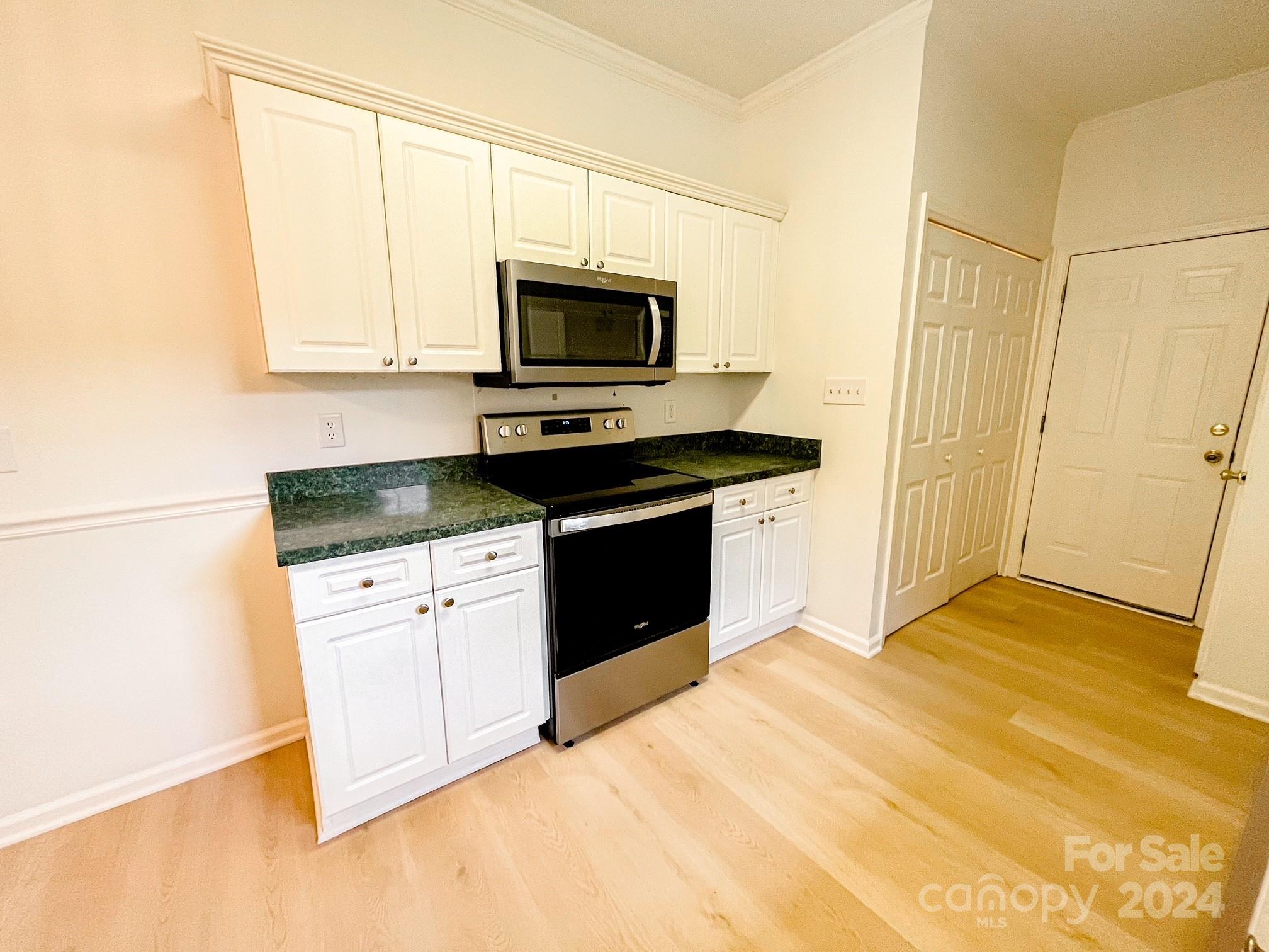 3079 River Ridge Drive Gastonia, NC 28056 - Photo 5 of 24 a kitchen with stainless steel appliances granite countertop a stove a sink and a microwave