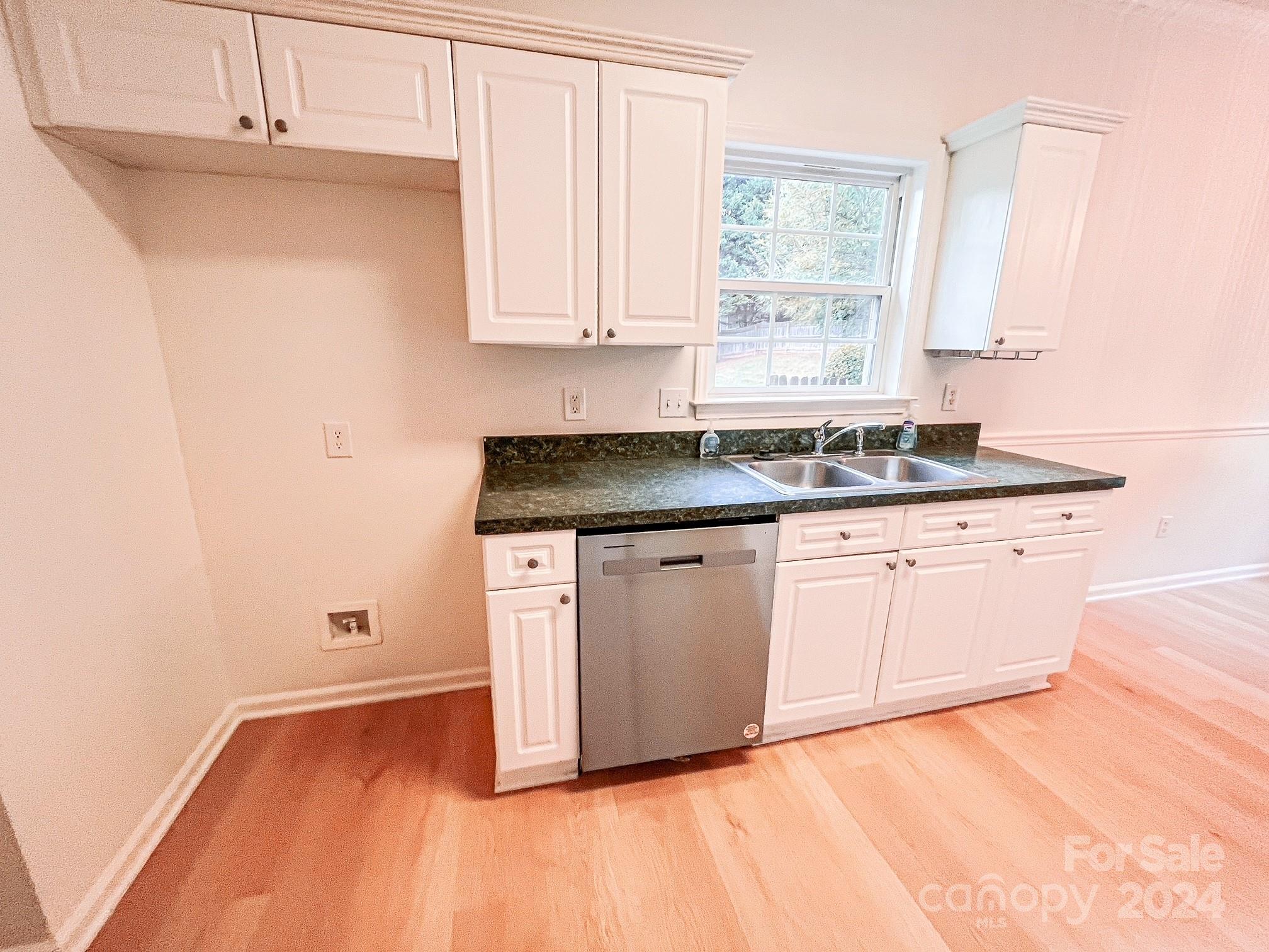 3079 River Ridge Drive Gastonia, NC 28056 - Photo 6 of 24 a kitchen with granite countertop white cabinets white appliances and granite counter tops