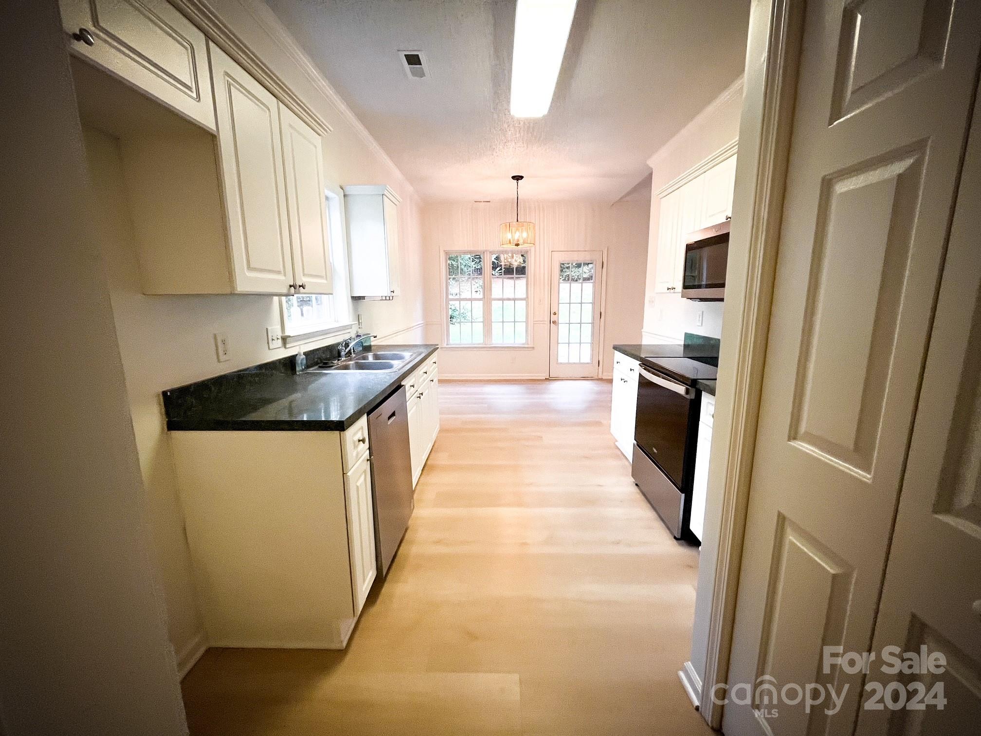 3079 River Ridge Drive Gastonia, NC 28056 - Photo 7 of 24 a kitchen with stainless steel appliances granite countertop a refrigerator a stove and a sink