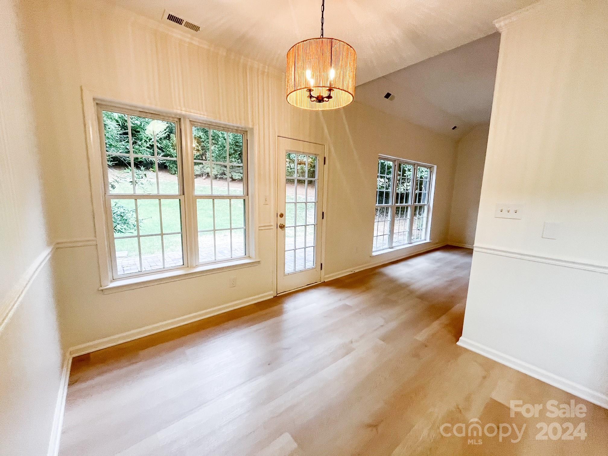 3079 River Ridge Drive Gastonia, NC 28056 - Photo 8 of 24 a view of an empty room with wooden floor and a window