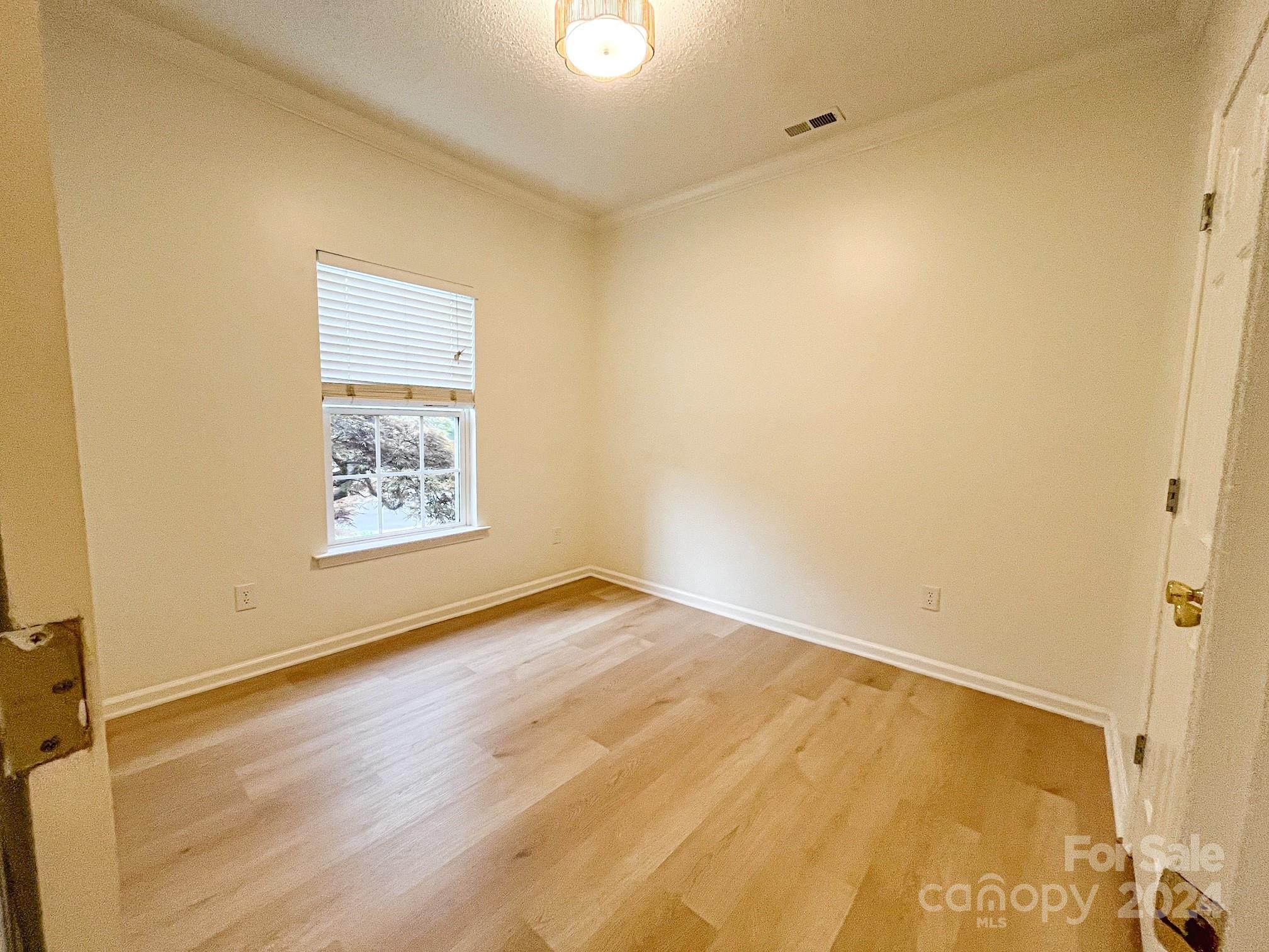 3079 River Ridge Drive Gastonia, NC 28056 - Photo 9 of 24 a view of an empty room with wooden floor and a window