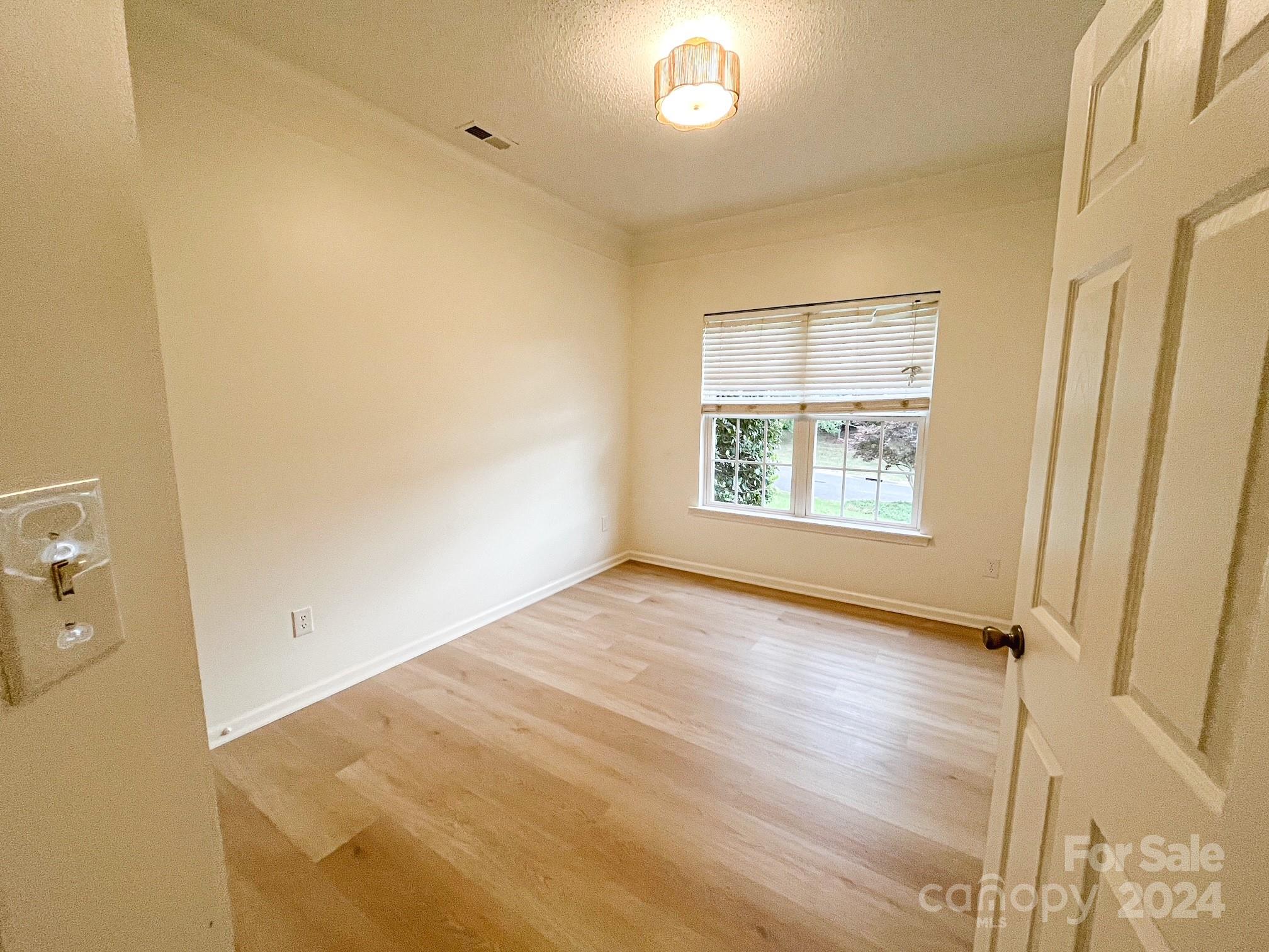 3079 River Ridge Drive Gastonia, NC 28056 - Photo 10 of 24 an empty room with wooden floor and windows