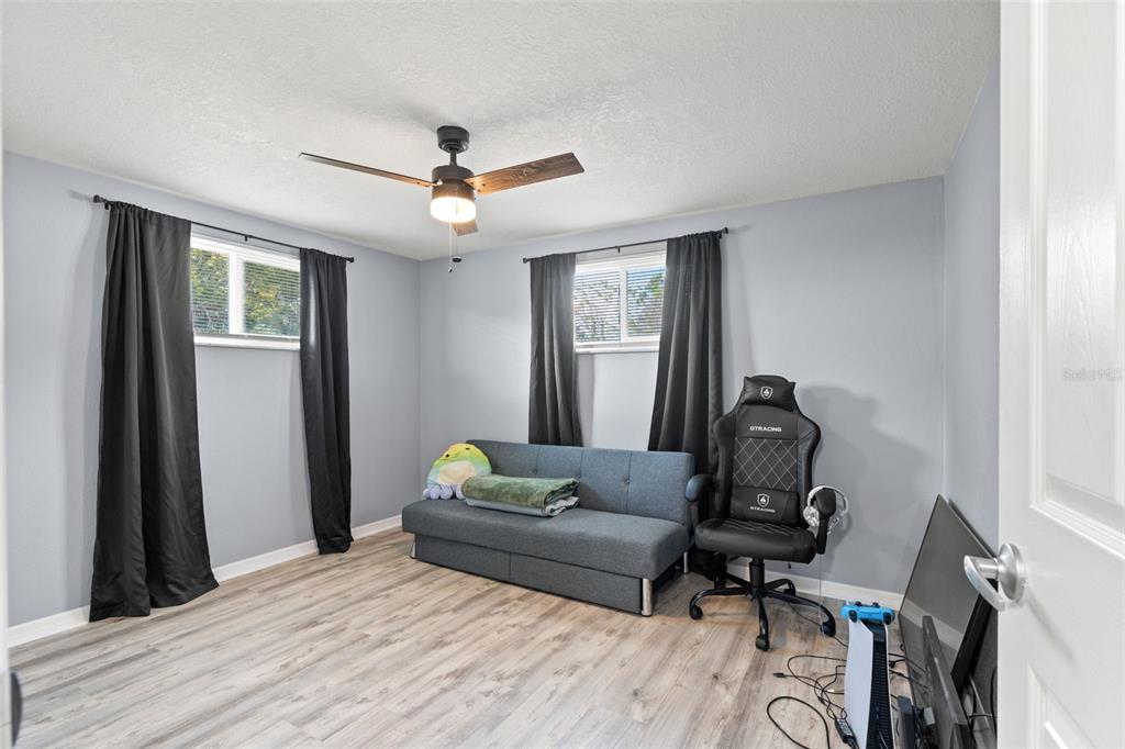 3709 Panola Drive New Port Richey, FL 34652 - Photo 13 of 36 a bedroom with a bed and wooden floor