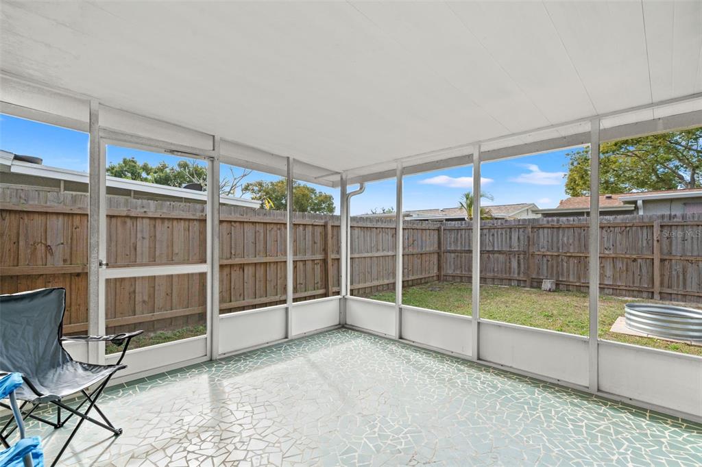 3709 Panola Drive New Port Richey, FL 34652 - Photo 25 of 36 a view of an empty room with wooden floor and windows