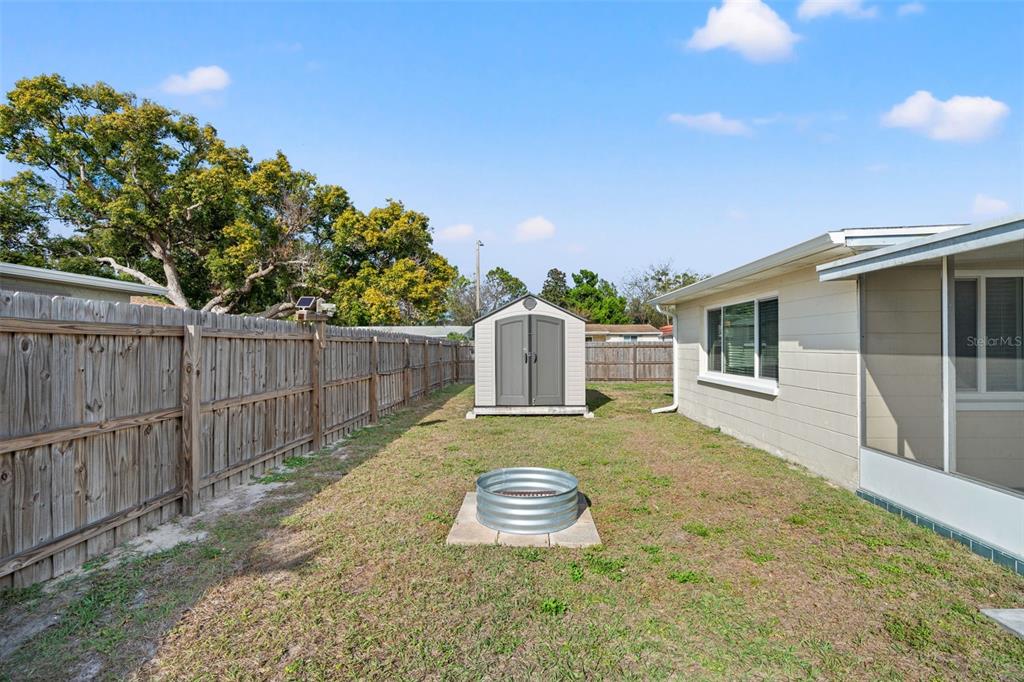 3709 Panola Drive New Port Richey, FL 34652 - Photo 30 of 36 a backyard of a house with table and chairs