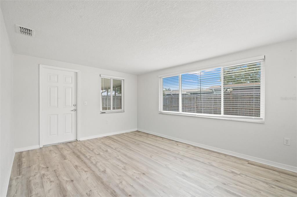 3709 Panola Drive New Port Richey, FL 34652 - Photo 5 of 36 a view of empty room with wooden floor and fan