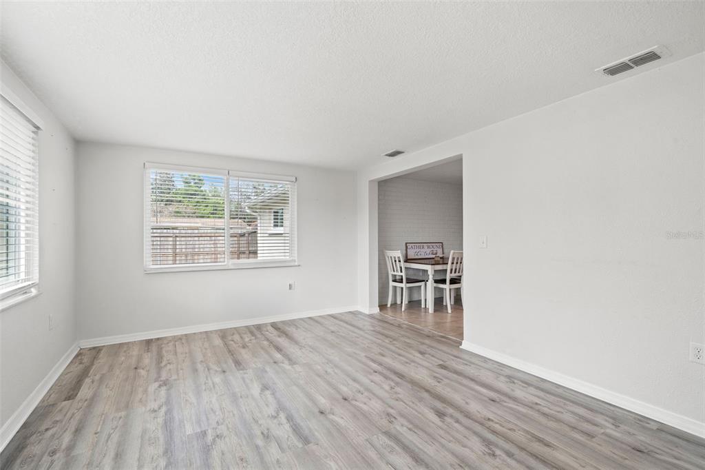 3709 Panola Drive New Port Richey, FL 34652 - Photo 6 of 36 a view of empty room with wooden floor and fan