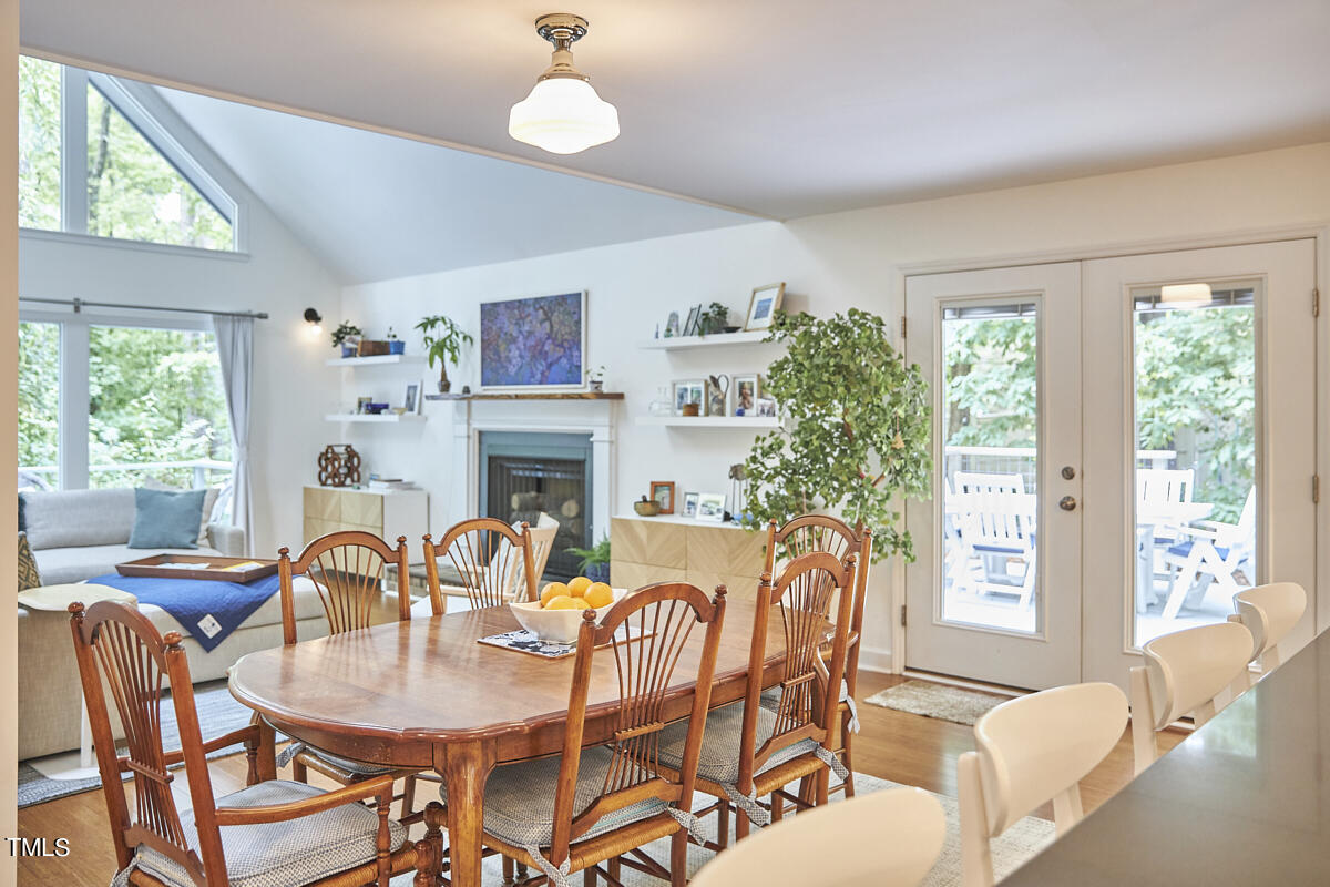 2803 McDowell Road Durham, NC 27705 - Photo 26 of 81 a dining room with furniture a fireplace and large windows