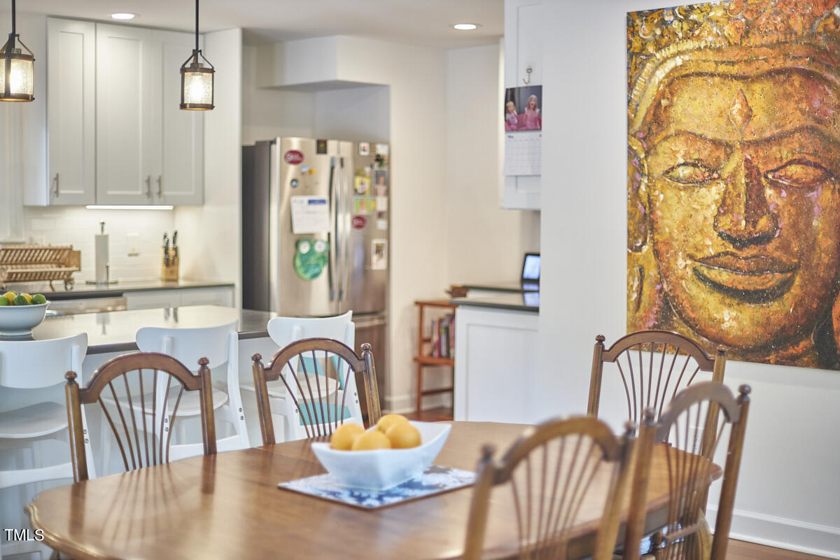 2803 McDowell Road Durham, NC 27705 - Photo 27 of 81 a dining room with furniture a chandelier and wooden floor