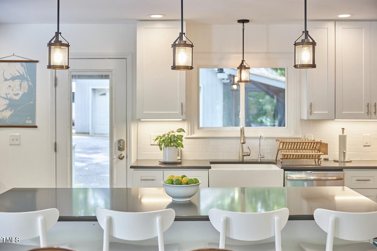 2803 McDowell Road Durham, NC 27705 - Photo 31 of 81 a living room with furniture and a chandelier