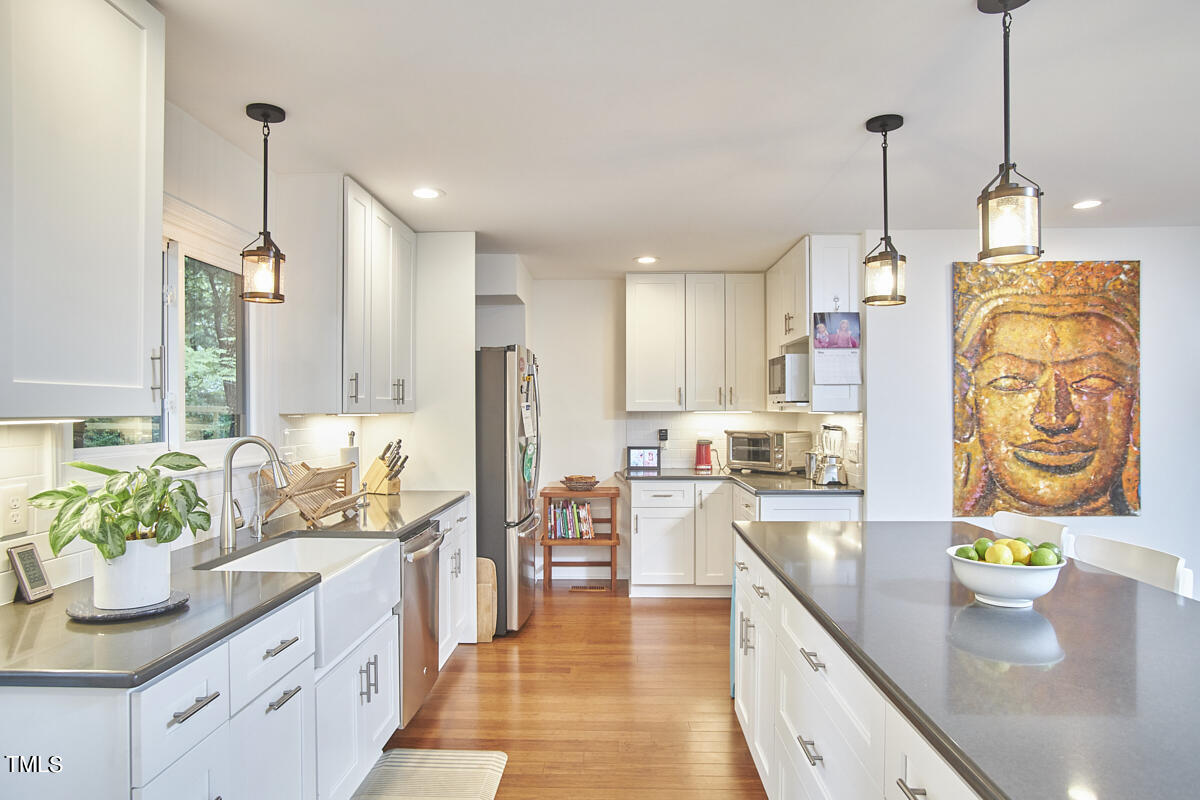 2803 McDowell Road Durham, NC 27705 - Photo 36 of 81 a kitchen with stainless steel appliances granite countertop sink stove and refrigerator