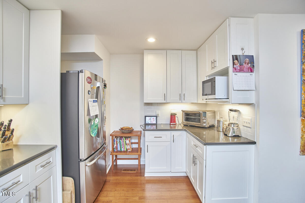 2803 McDowell Road Durham, NC 27705 - Photo 39 of 81 a kitchen with stainless steel appliances granite countertop a refrigerator sink and cabinets
