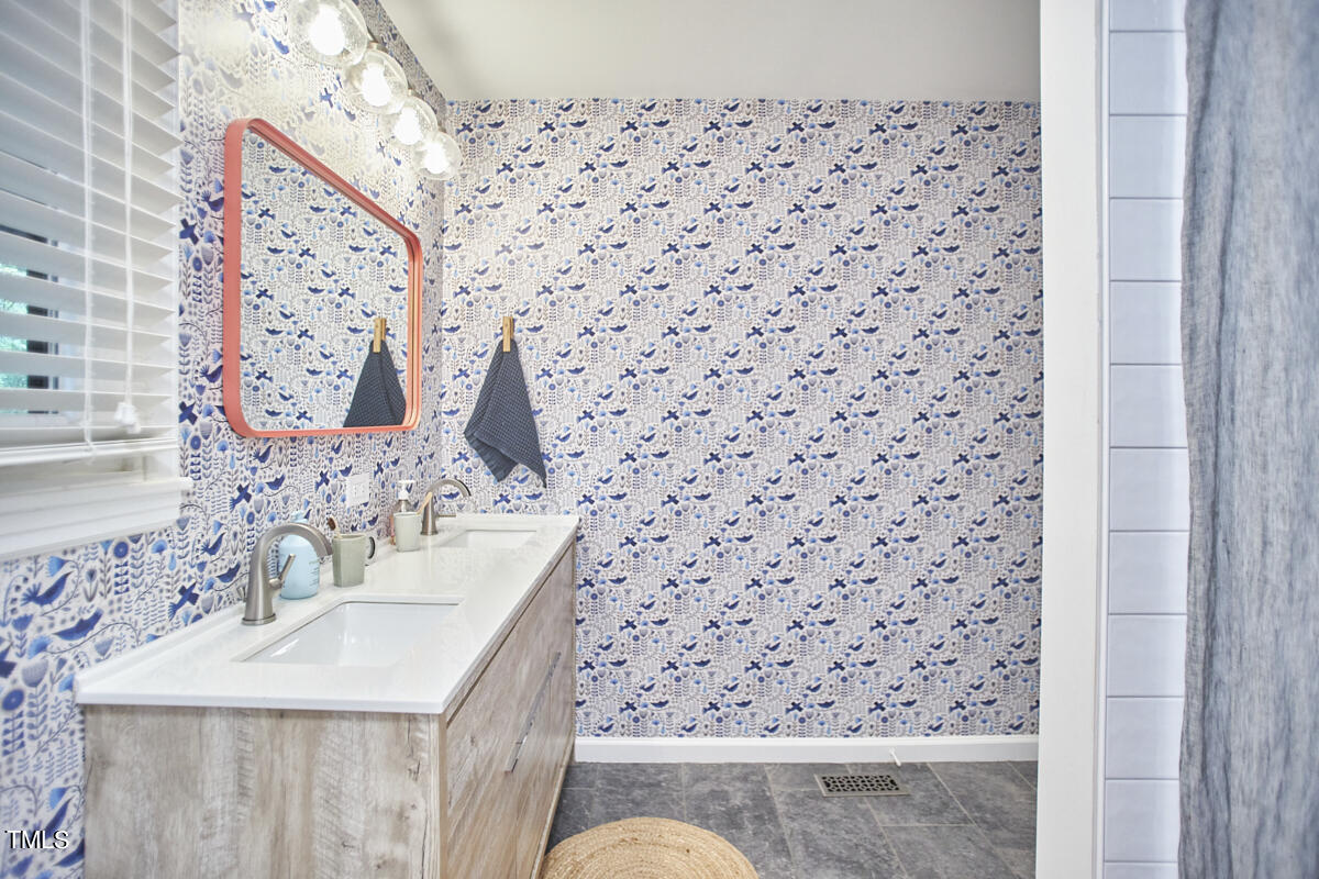 2803 McDowell Road Durham, NC 27705 - Photo 48 of 81 a bathroom with a sink and a mirror