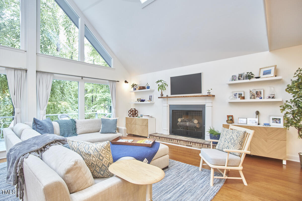 2803 McDowell Road Durham, NC 27705 - Photo 10 of 81 a living room with furniture a fireplace and a large window