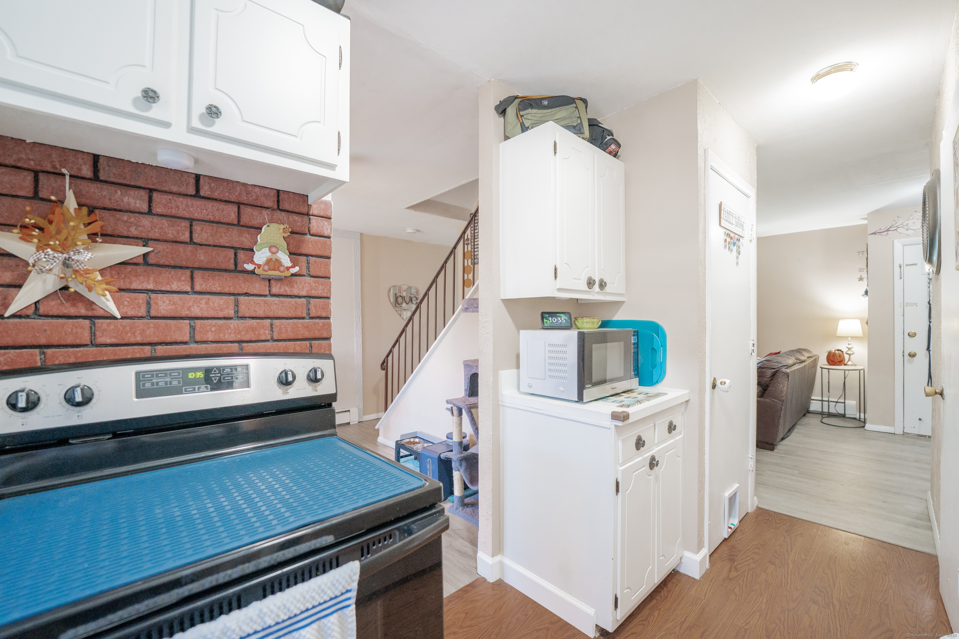 48 Round Tree Drive, Unit 5 Naugatuck, CT 06770 - Photo 4 of 13 a view of kitchen and utility room with wooden floor