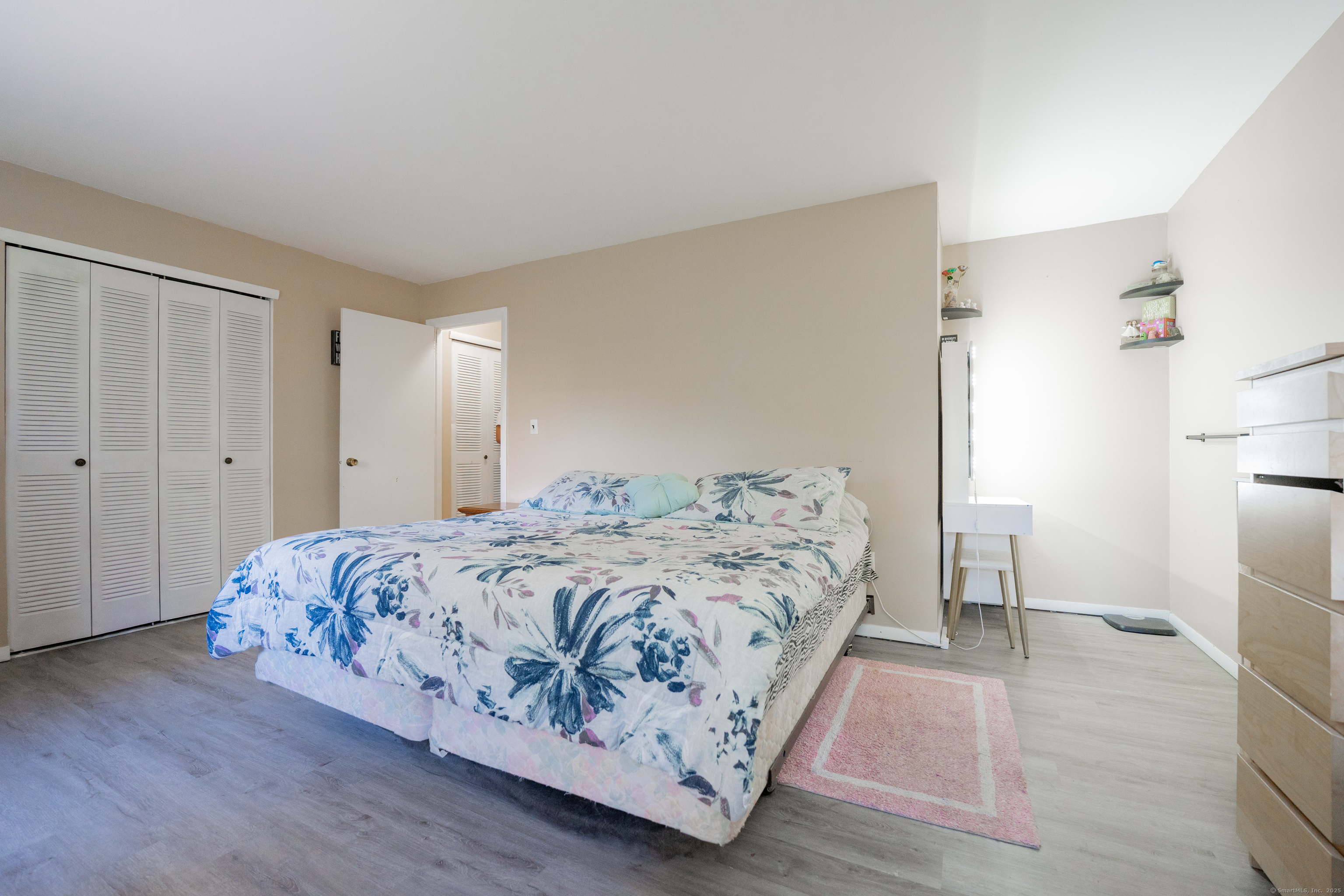 48 Round Tree Drive, Unit 5 Naugatuck, CT 06770 - Photo 8 of 13 a bedroom with a bed and a refrigerator