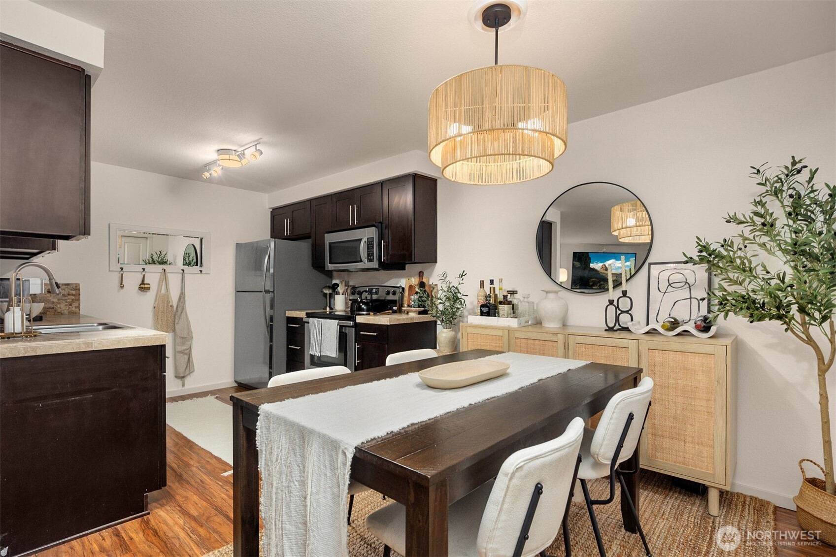 215 9th Street, Unit D102 Kirkland, WA 98033 - Photo 11 of 32 a kitchen with a dining table and chairs in it