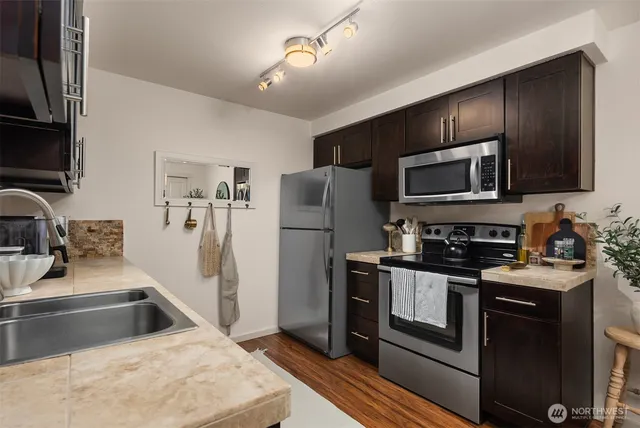 a kitchen with a sink stove and refrigerator