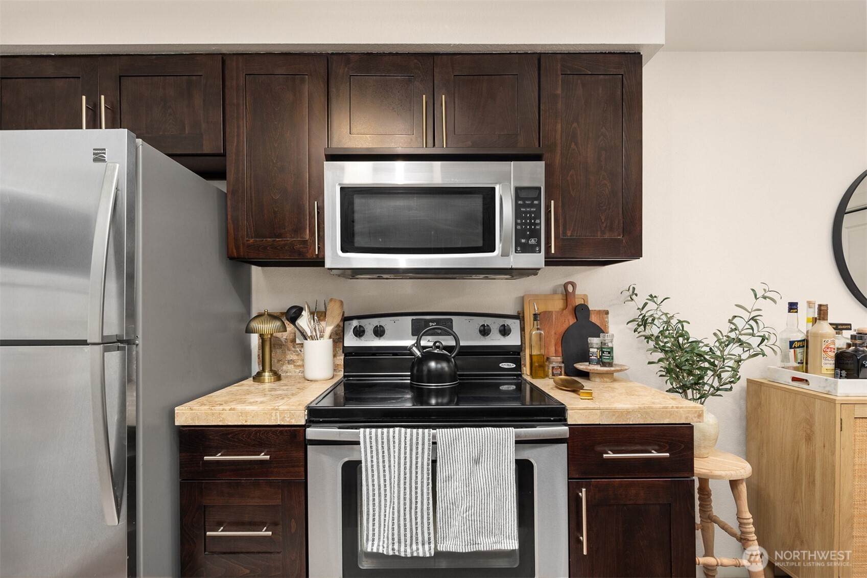 215 9th Street, Unit D102 Kirkland, WA 98033 - Photo 15 of 32 a kitchen with stainless steel appliances a stove microwave and refrigerator
