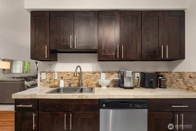 a kitchen with granite countertop wood cabinets and sink