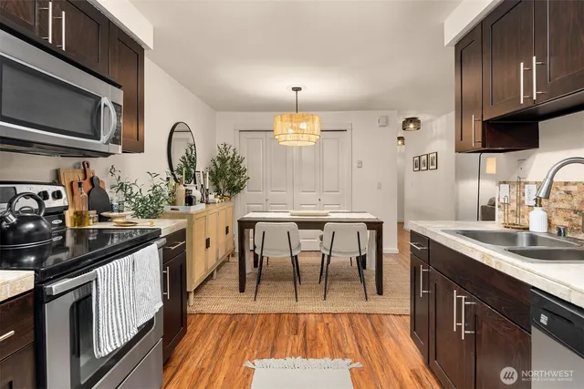 a kitchen with granite countertop a sink appliances and cabinets
