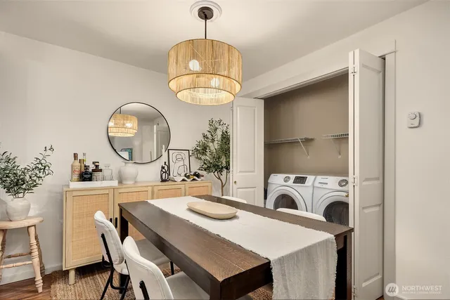 a view of a dining room with furniture a chandelier and wooden floor