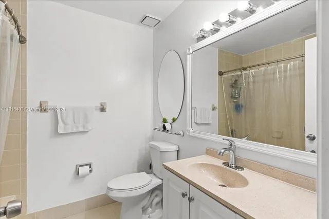 a bathroom with a shower curtain and a bathtub
