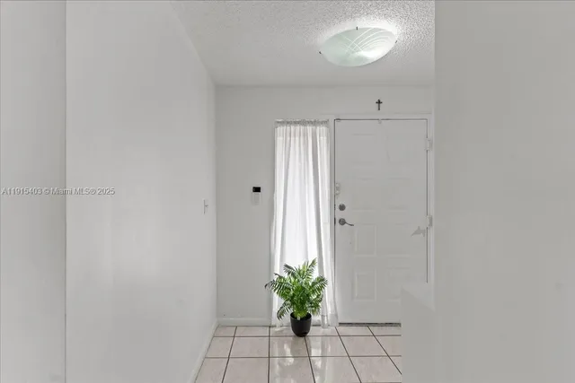 a view of hallway with furniture and a potted plant