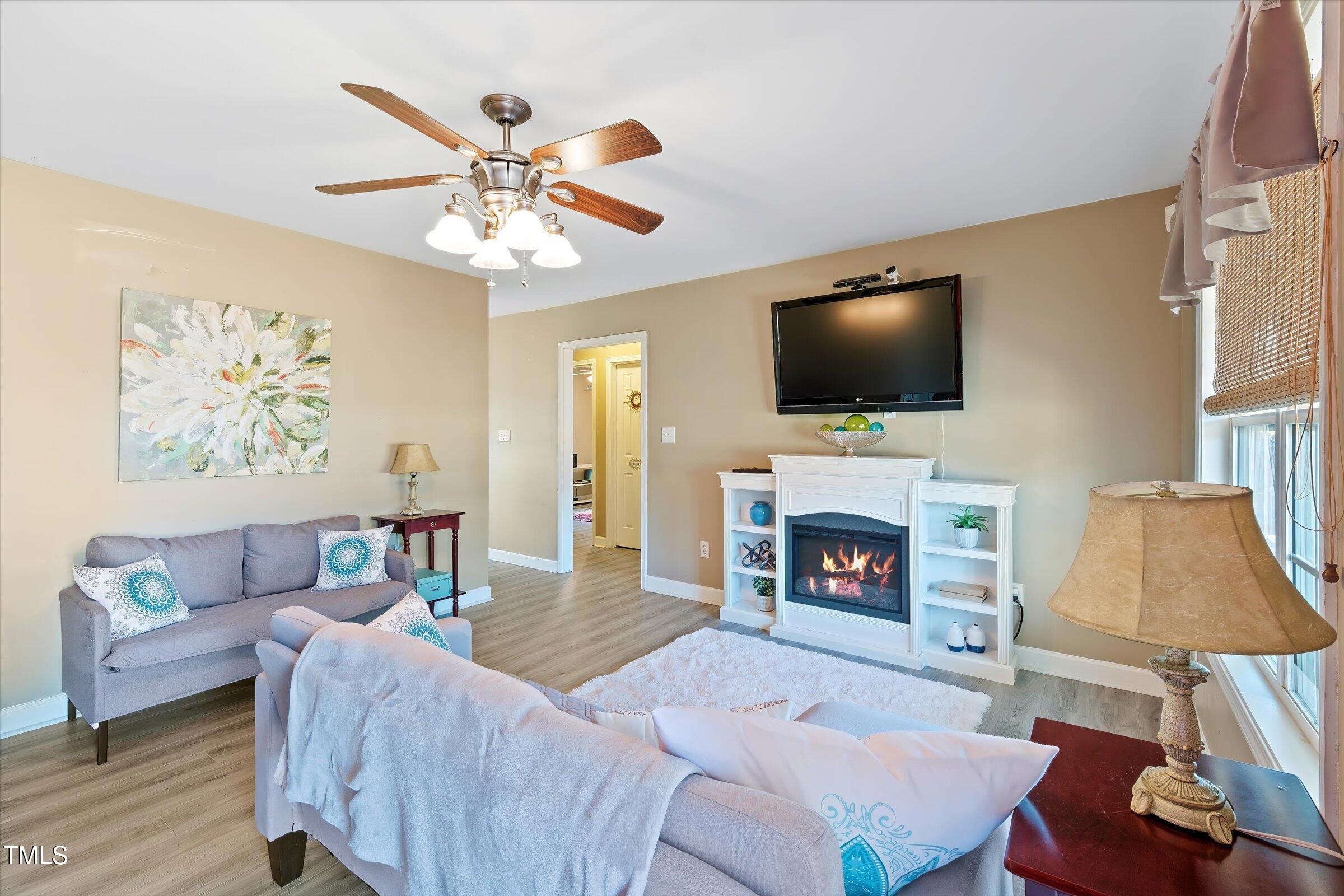 21 Birchwood Circle Coats, NC 27521 - Photo 13 of 36 a living room with furniture a fireplace and a flat screen tv