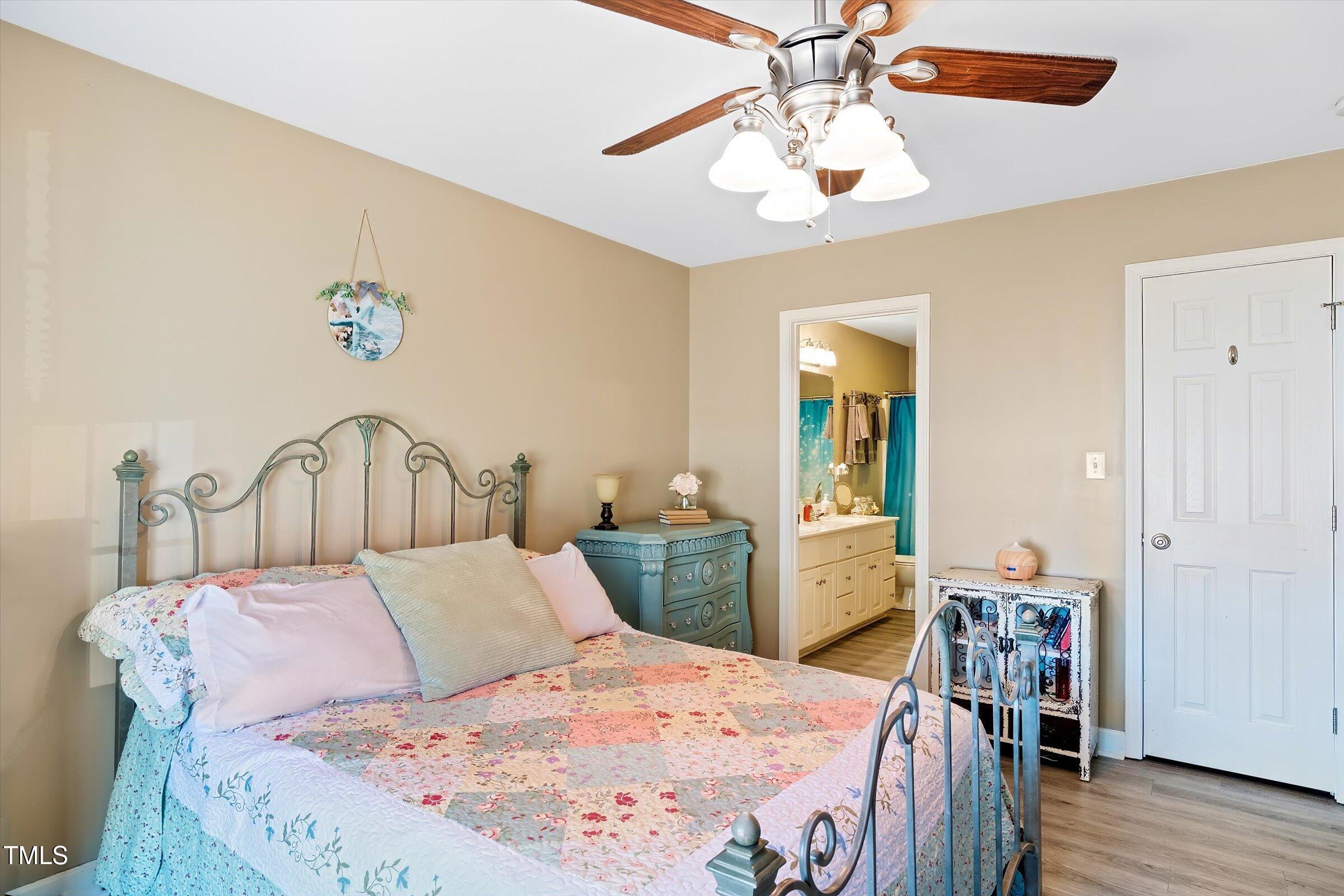 21 Birchwood Circle Coats, NC 27521 - Photo 18 of 36 a bed sitting in a bedroom and a chandelier