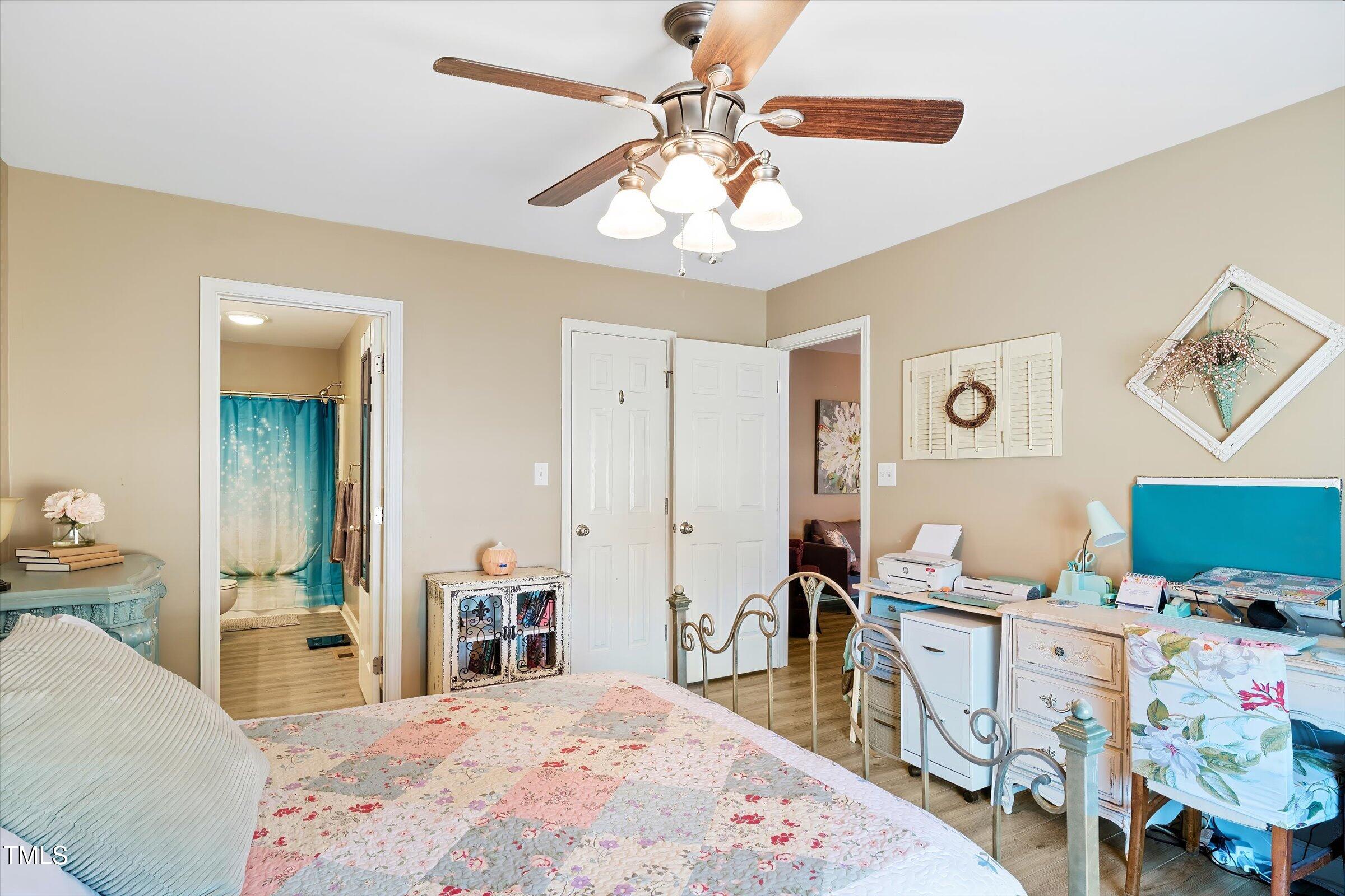 21 Birchwood Circle Coats, NC 27521 - Photo 19 of 36 a bedroom with a bed and a chandelier