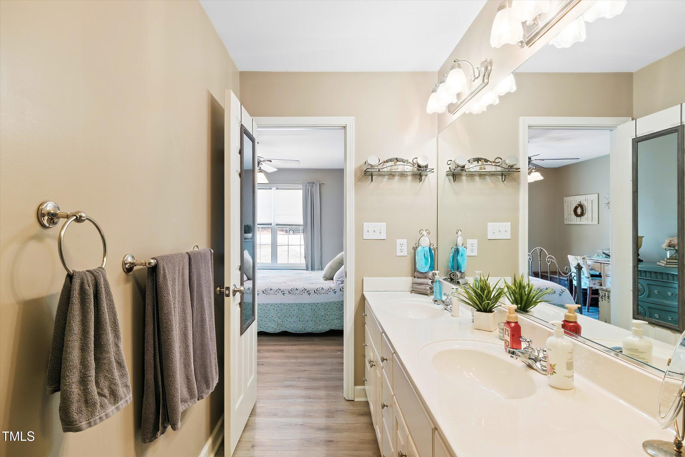 21 Birchwood Circle Coats, NC 27521 - Photo 21 of 36 a bathroom with a sink a mirror and shower