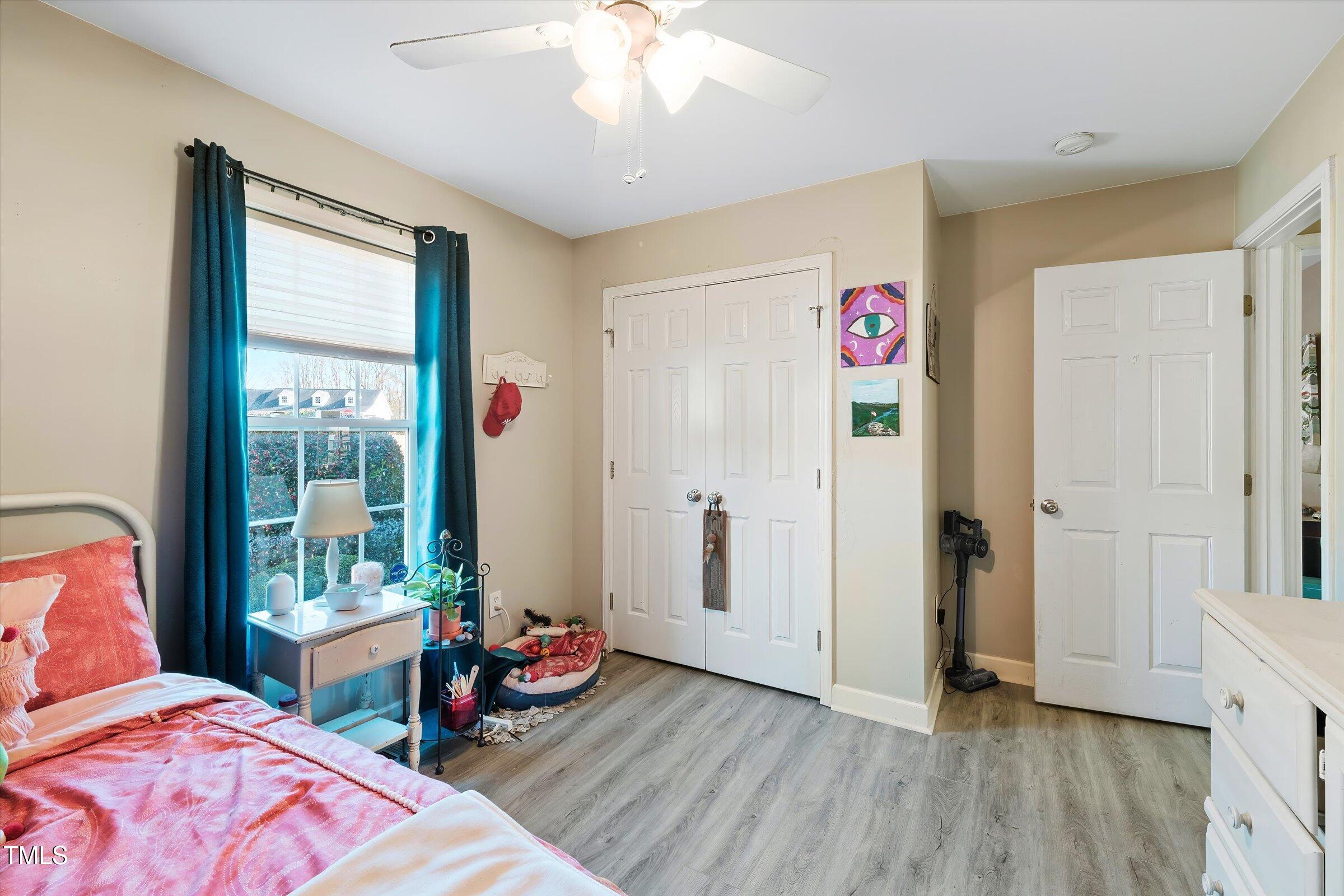 21 Birchwood Circle Coats, NC 27521 - Photo 23 of 36 a bedroom with bed and a chandelier