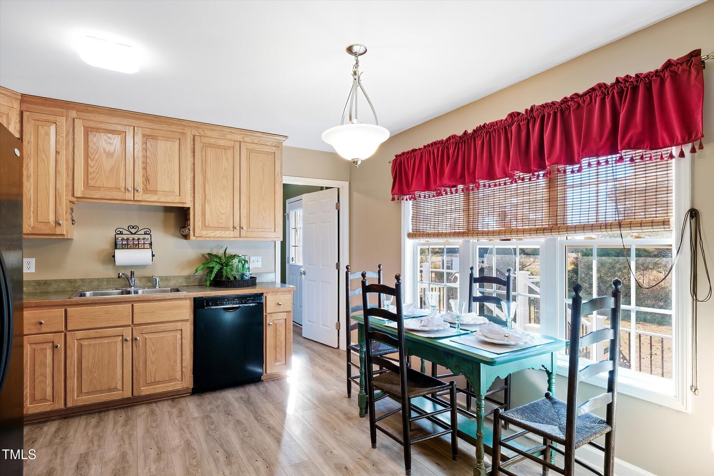 21 Birchwood Circle Coats, NC 27521 - Photo 28 of 36 a kitchen with stainless steel appliances granite countertop a kitchen island hardwood floor a dining table and chairs