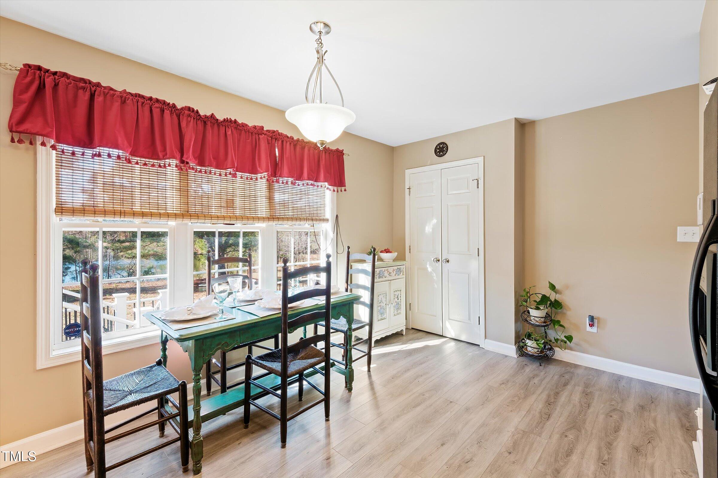 21 Birchwood Circle Coats, NC 27521 - Photo 30 of 36 a dining room with furniture large windows and wooden floor