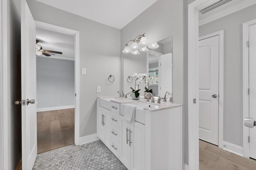 7631 Meadow Road Dallas, TX 75230 - Photo 24 of 40 A bright bathroom featuring a dual vanity